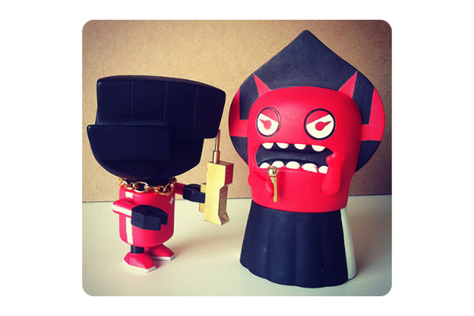 Red demon robots with early '90s style cellular phone